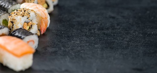 Slate slab with some Sushi (selective focus, close-up shot)