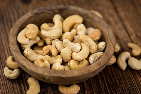Some roasted Cashew Nuts as detailed close up shot (selective focus)