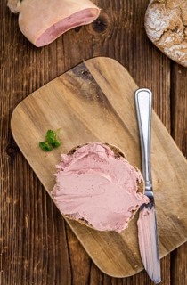 Homemade Liverwurst Sandwich on an wooden table (selective focus) as detailed close-up shot