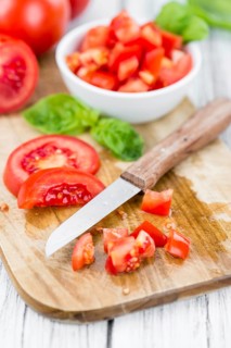 Diced Tomatoes on a vintage background as detailed close-up shot (selective focus)