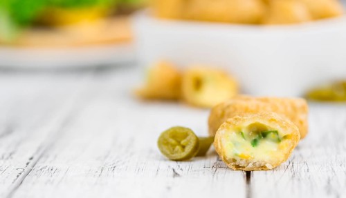 Portion of homemade Chili Cheese Nuggets on wooden background (selective focus, close-up shot)