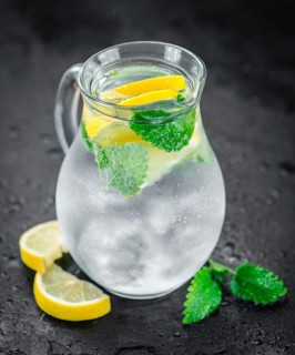 Homemade Lemonade on vintage background (selective focus, close-up shot)