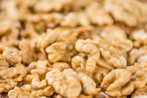 Walnut kernels on a vintage background as detailed close-up shot (selective focus)