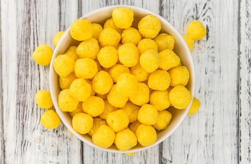 Cheese Balls on rustic wooden background (close-up shot)