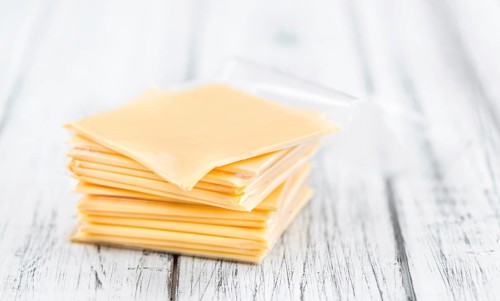 Portion of sliced Cheese (close-up shot, selective focus)