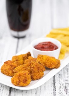 Homemade Chicken Nuggets on vintage background (selective focus, close-up shot)