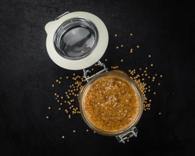 Fresh made German Cuisine (sweet Mustard) on a vintage background (close-up shot)