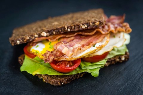 Slate slab with a Bacon and Egg Sandwich (close-up shot)