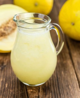 Homemade Honeydew Melon Smoothie on wooden background (selective focus)