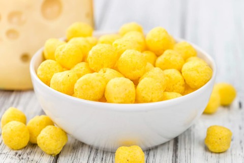 Cheese Balls on rustic wooden background (close-up shot)