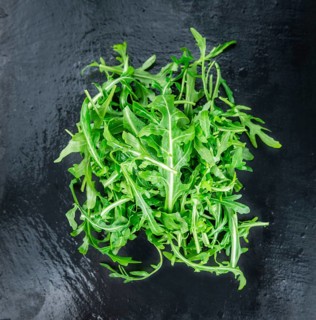 Portion of fresh Arugula (detailed close-up shot, selective focus)