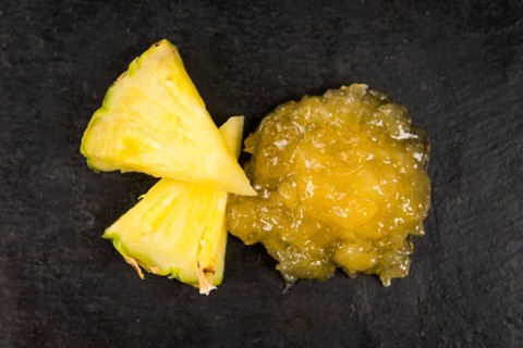 Portion of Pineapple Jam as detailed close up shot on a slate slab, selective focus