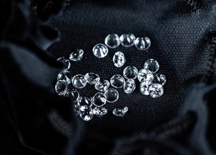 Small Diamonds on dark background as close up shot (selective focus)