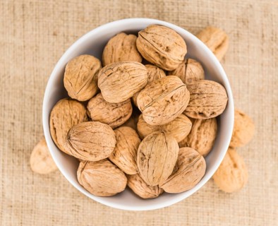 Walnuts on a vintage background as detailed close-up shot (selective focus)