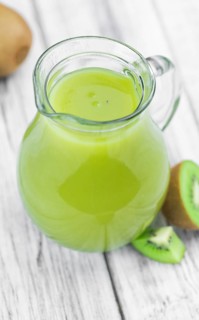 Kiwi Smoothie (selective focus) on an old and vintage background (homemade)