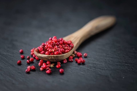 Pink Peppercorns on a vintage background as detailed close-up shot, selective focus