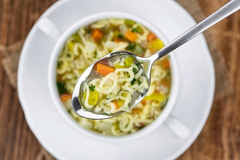 Portion of fresh made Alphabet Soup (selective focus, close-up shot)