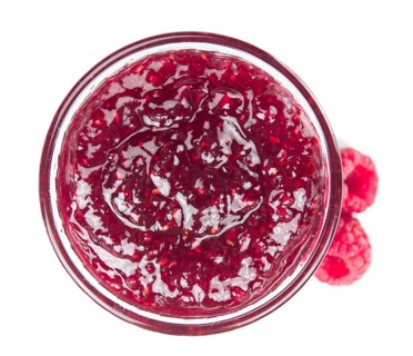 Fresh made Raspberry Jam isolated on white background, close-up shot