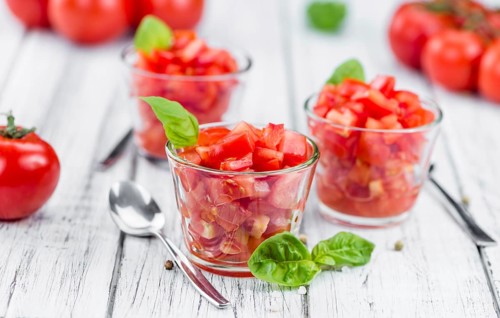 Homemade Cutted Tomatoes on vintage background (selective focus, close-up shot)