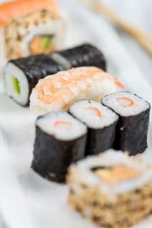 Portion of Sushi on a wooden table (selective focus, close-up shot)