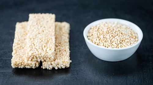 Slate slab with fresh made Quinoa Bars (close-up shot, selective focus)