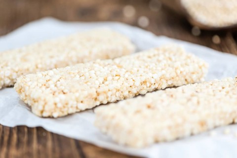 Quinoa Bars on a wooden table as detailed close-up shot (selective focus)