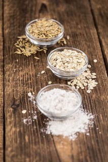 Some Oat Flour on a vintage wooden table (selective focus, close-up shot)