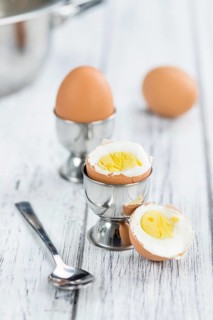 Some boiled Eggs (close-up shot, selective focus) on an old wooden table