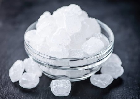 Slate slab with a portion of white Rock Candy (selective focus, close-up picture)