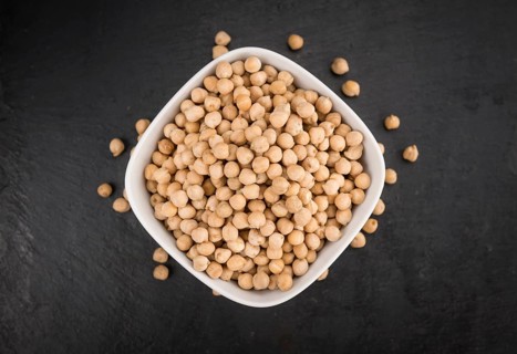 Portion of dried Chickpeas on a rustic slate slab, selective focus, close-up shot