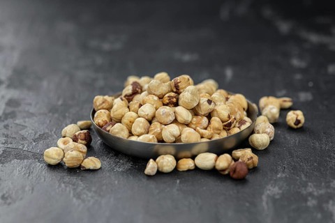 Peeled Hazelnuts as detailed close up shot (selective focus)