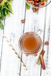 Rhubarb Juice on a rustic background (close up shot, selective focus)