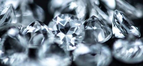 Small Diamonds on dark background as close up shot (selective focus)