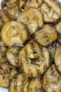 Fresh made Zucchinis (grilled) on an old and rustic wooden table (selective focus, close-up shot)