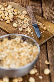 Freshly chopped Hazelnuts as detailed close up shot (selective focus)