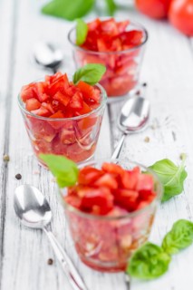 Homemade Cutted Tomatoes on vintage background (selective focus, close-up shot)