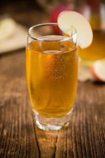 Fresh made Apple Cider on a vintage background (close-up shot)