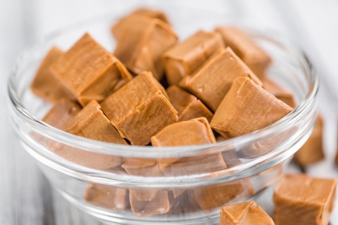 Caramel on a vintage background as detailed close-up shot (selective focus)