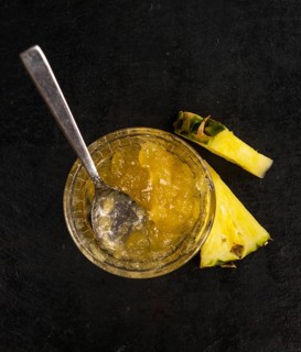 Portion of Pineapple Jam as detailed close up shot on a slate slab, selective focus