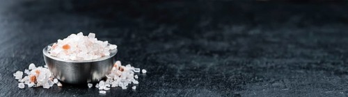 Pink Salt on a vintage background as detailed close-up shot (selective focus)