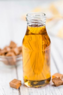 Portion of fresh Caramel Sirup (close-up shot, selective focus)