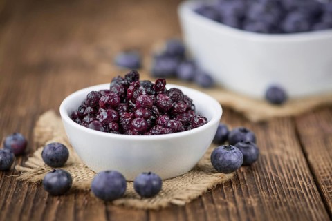 Preserved Blueberries on a vintage background as detailed close-up shot, selective focus