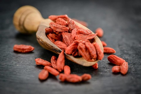 Fresh made Dried Goji Berries on a vintage background (close-up shot)