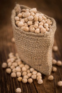 Chickpeas on a vintage background as detailed close-up shot, selective focus
