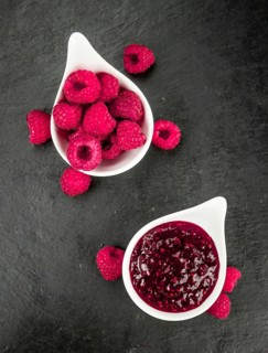 Fresh made Raspberry Jam on a vintage background as detailed close-up shot