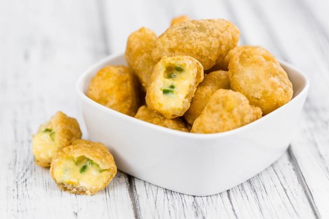 Chili Cheese Nuggets on a vintage background as detailed close-up shot (selective focus)