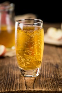Apple Cider as high detailed close-up shot on a vintage wooden table (selective focus)
