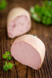 Liverwurst on a vintage background as detailed close-up shot (selective focus)