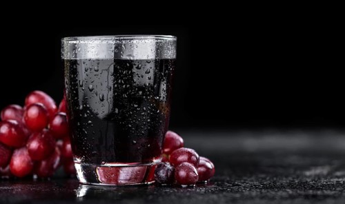 Some fresh Red Grape Juice (selective focus, close-up shot)