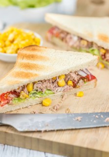 Wooden table with a fresh made Tuna Sandwich (selective focus, close-up shot)